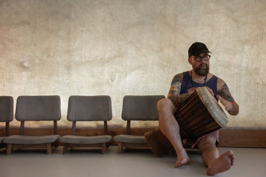 Drummer sitting barefoot in an empty waiting room