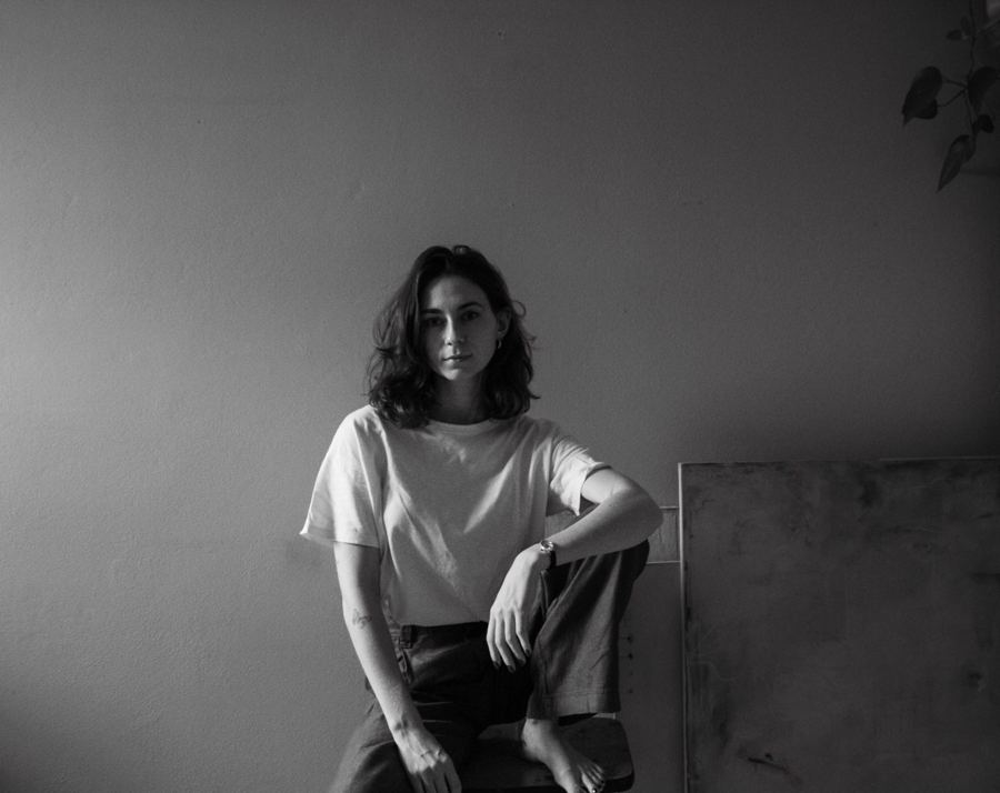 Black and white studio portrait, seated
